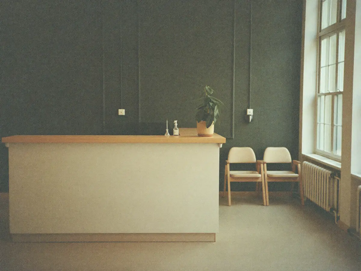 A calm dental practice reception with morning light across the counter.