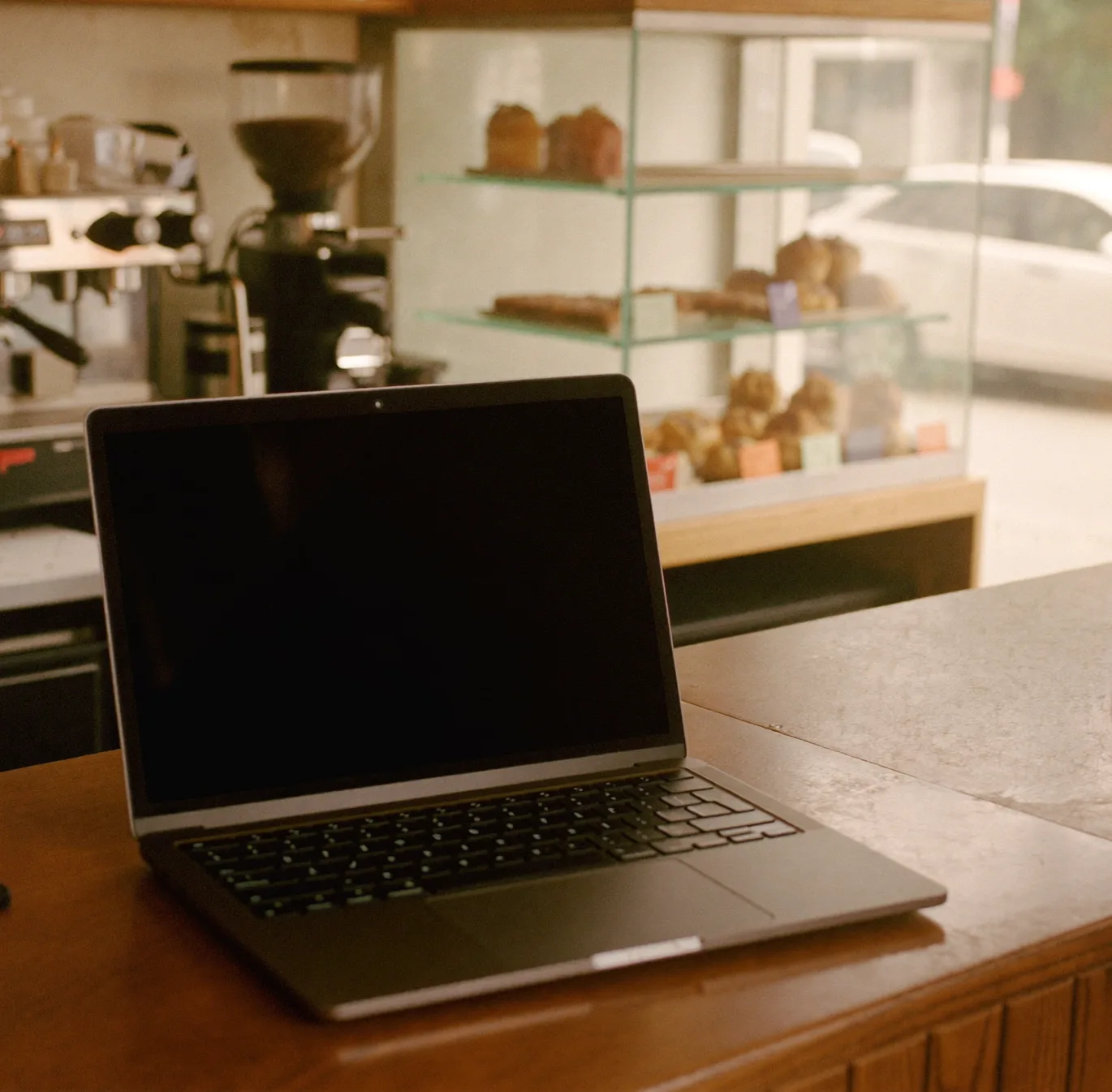 A laptop open on a shop counter