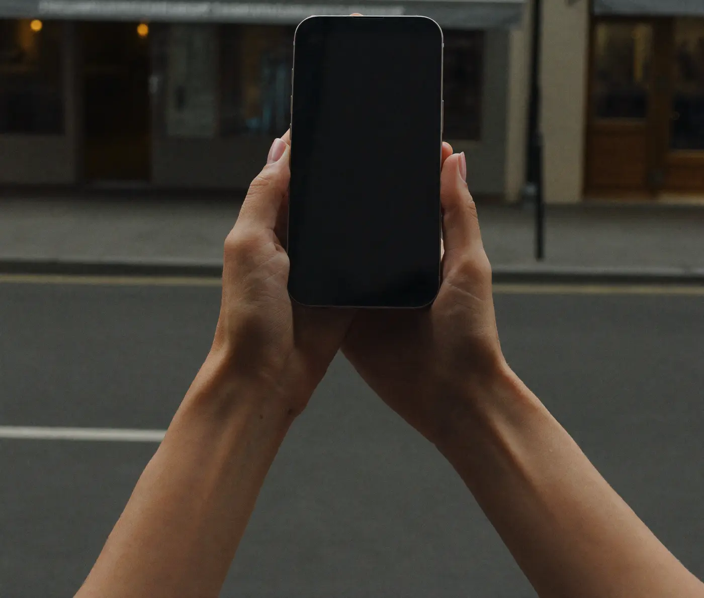 Someone looking something up on their phone in the street